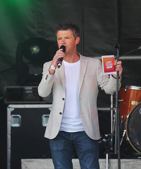 Event host Carl Ward on stage presenting live at the Guernsey Together Festival.