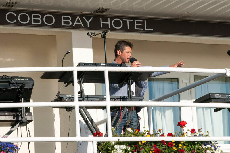 Carl Ward hosting and entertaining the crowds live on stage for a Cobo Balcony Gig event in Guernsey.